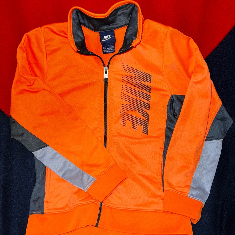 Nike kid’s full zip warm up jacket. Kid’s size 7.    Thin.bright orange size